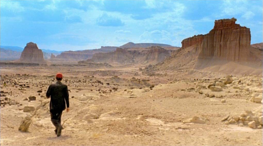 Harry Dean Stanton walking into the desert